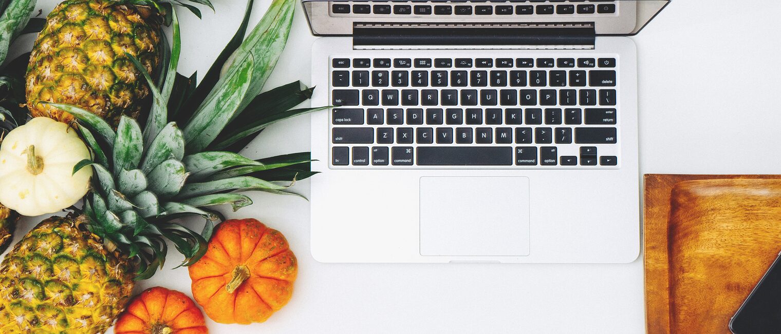 white-macbook-near-pineapple-and-pumpkin-204686